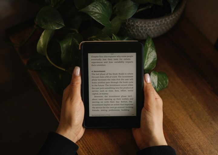 Female hands holding an -ebook reader.