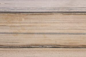 Close-up on a paper stack in different shades of cream.