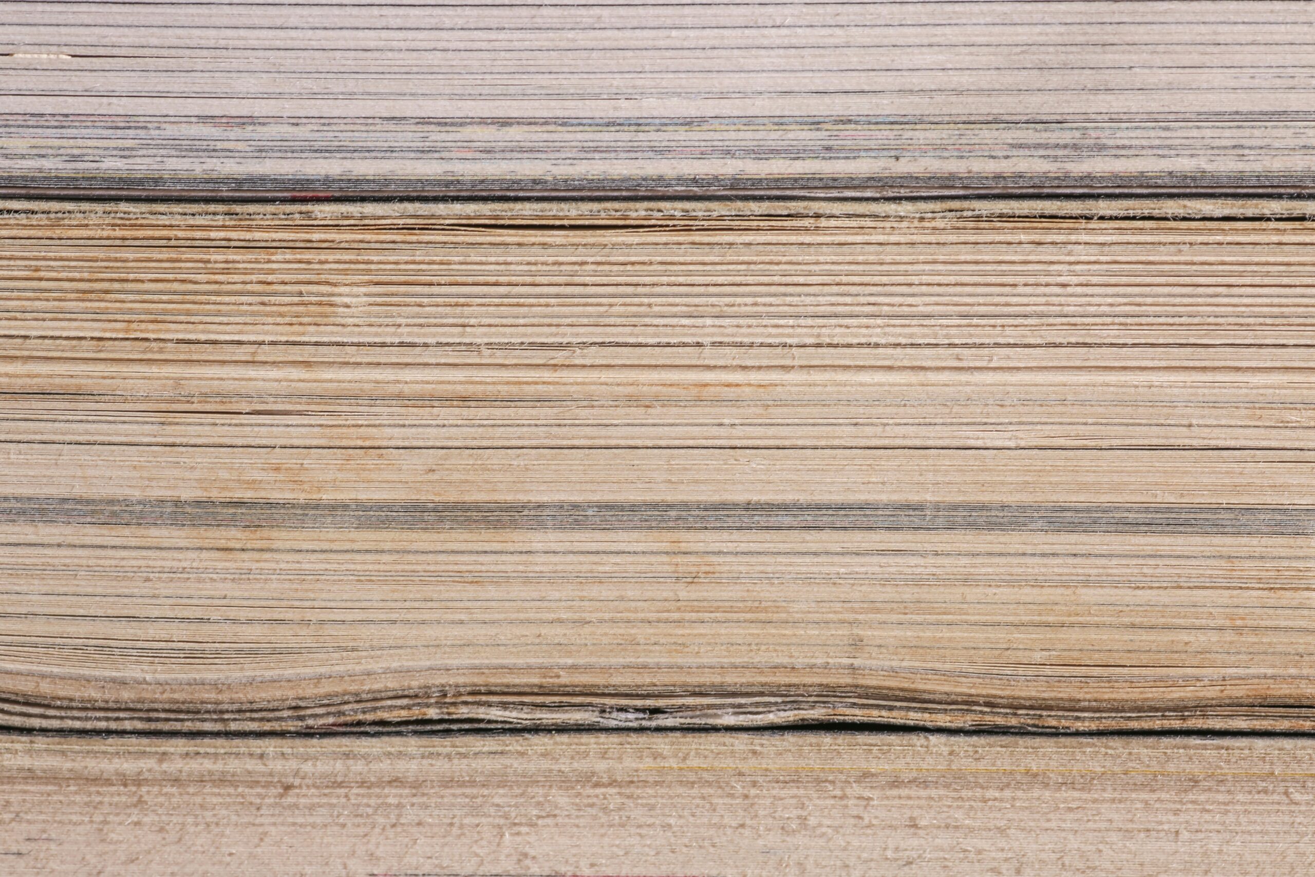 Close-up on a paper stack in different shades of cream.